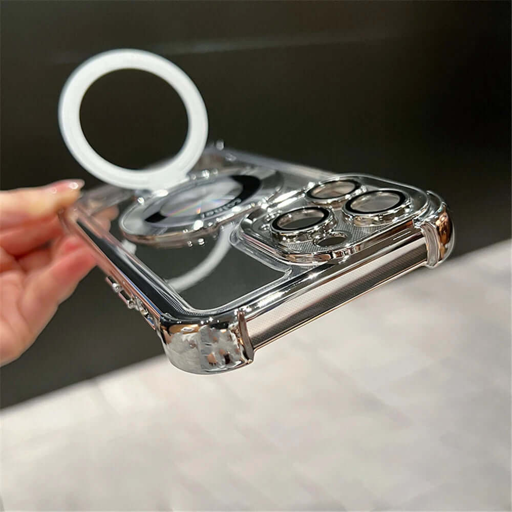 Clear phone case with metallic accents and ring holder on a marble surface