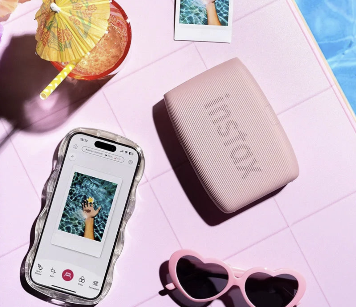 Wireless mini photo printer from Tech Viral To You Limited printing photos instantly from a phone, compact device with printed photo visible.