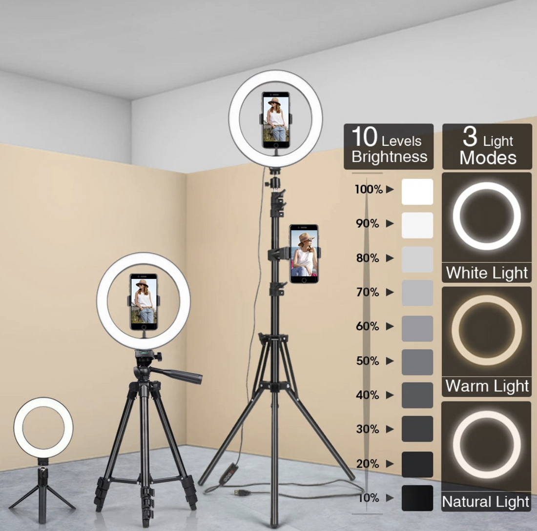 Ring light with tripod stand and smartphone holder, with lighting mode indicators on a plain background.