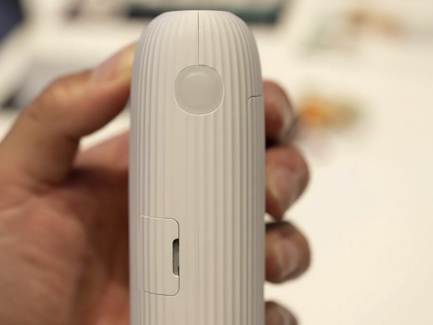 Wireless mini photo printer by Tech Viral To You Limited printing a photo from a smartphone wirelessly.