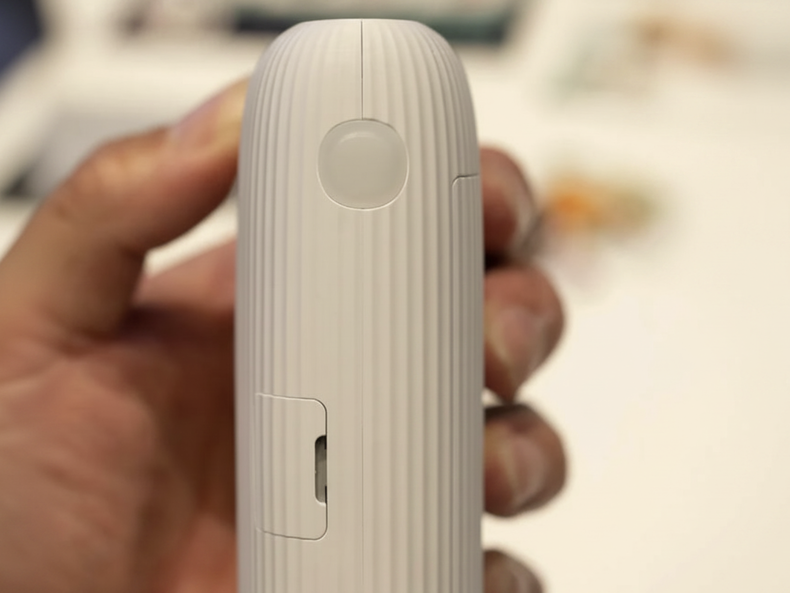 Wireless mini photo printer by Tech Viral To You Limited printing a photo from a smartphone wirelessly.