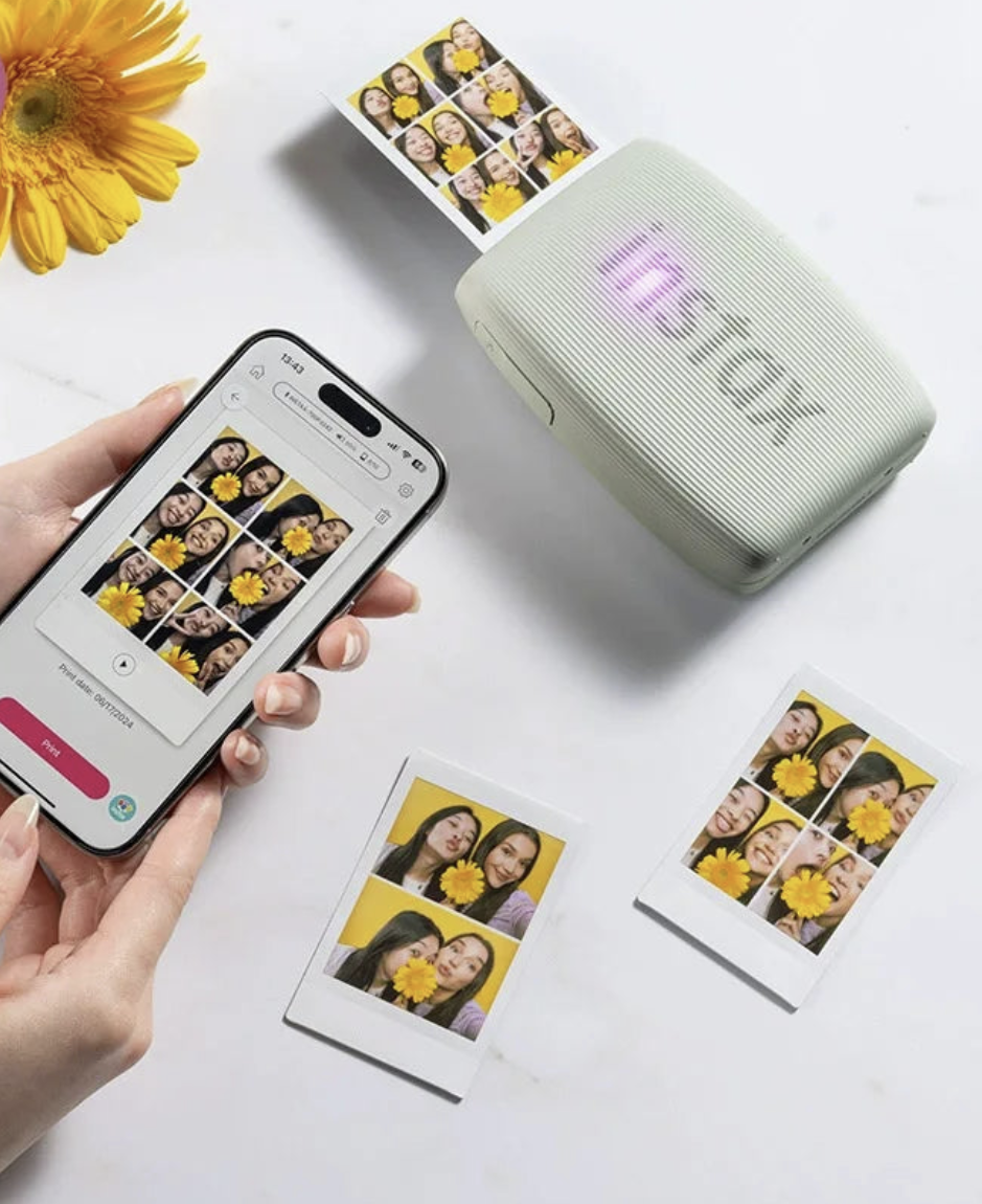 Wireless mini photo printer from Tech Viral To You Limited printing a photo directly from a smartphone. Compact and portable design.