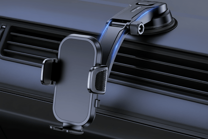 Universal car phone holder mounted on a car dashboard, featuring gravity design and auto-grip technology.